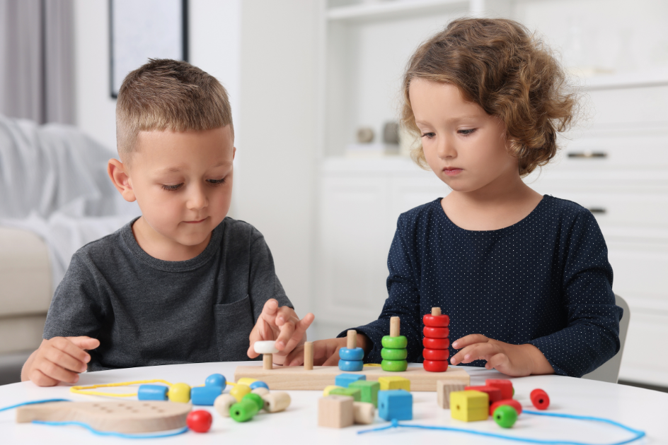 Two children playing with wooden toys